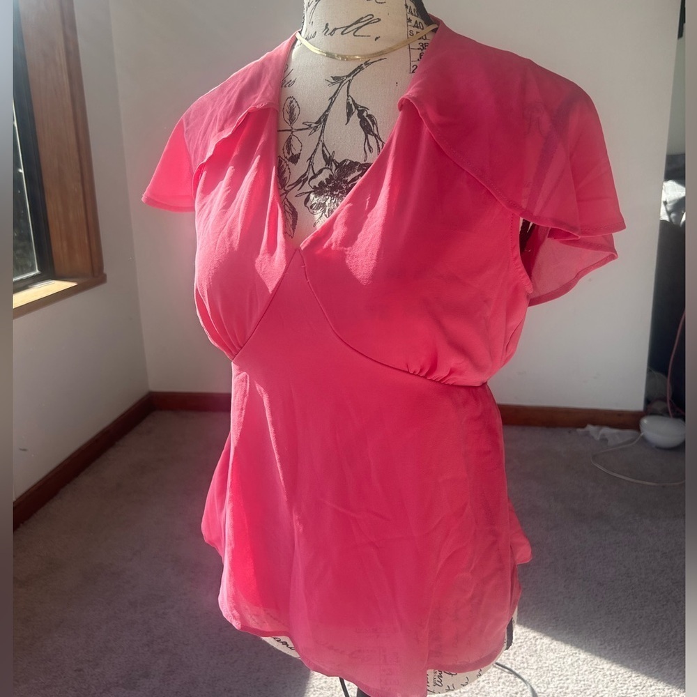 Airy light weight blouse, fit and flare style with a caped back shoulder